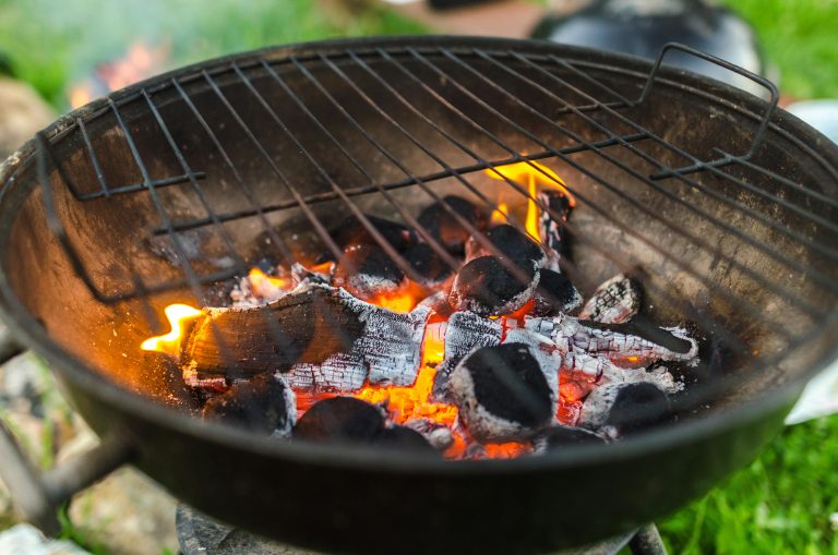 A detailed view of burning charcoal in a BBQ grill, perfect for outdoor cooking.