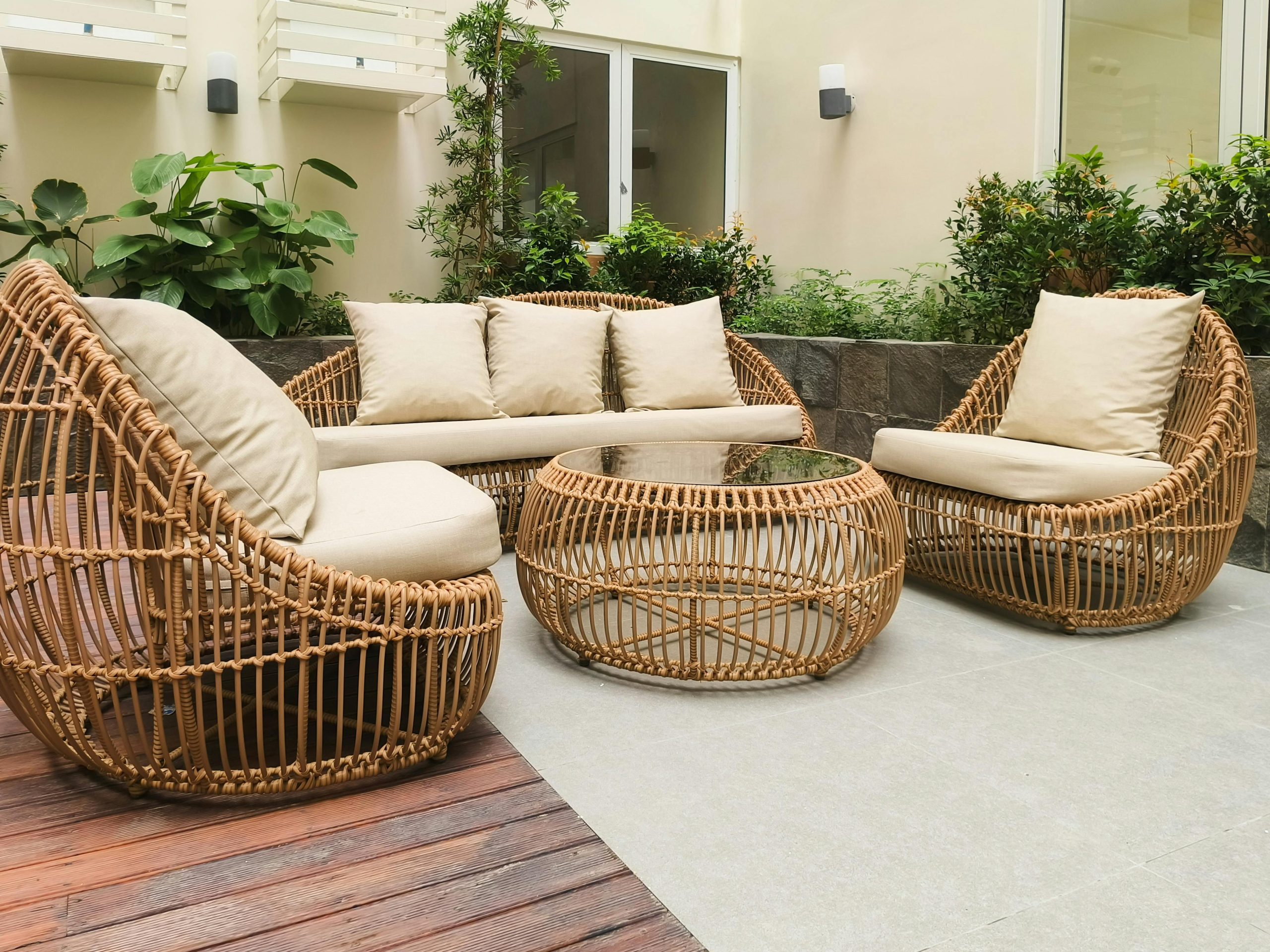 Top 10 Patio & Outdoor Furniture Sets for a Stylish Backyard in 2026 Outdoor seating with rattan furniture set in a lush garden patio, ideal for relaxation and gatherings.